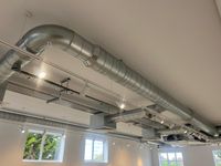 Exposed ceiling ductwork and cable tray cleaned of construction dust